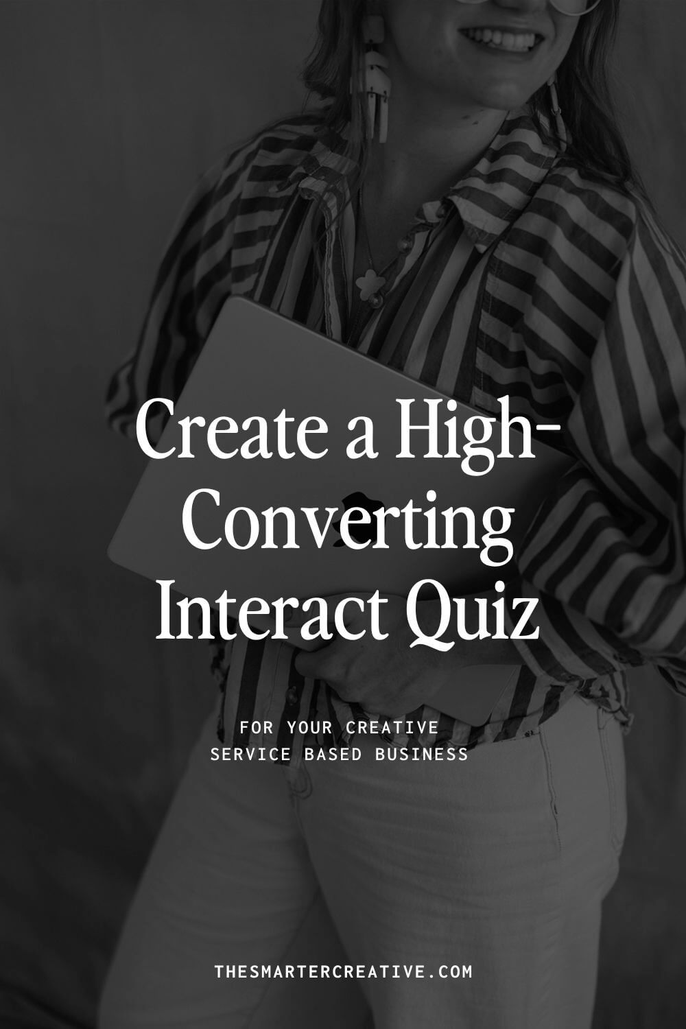 Woman in striped shirt working on laptop creating an Interact quiz for her service-based business